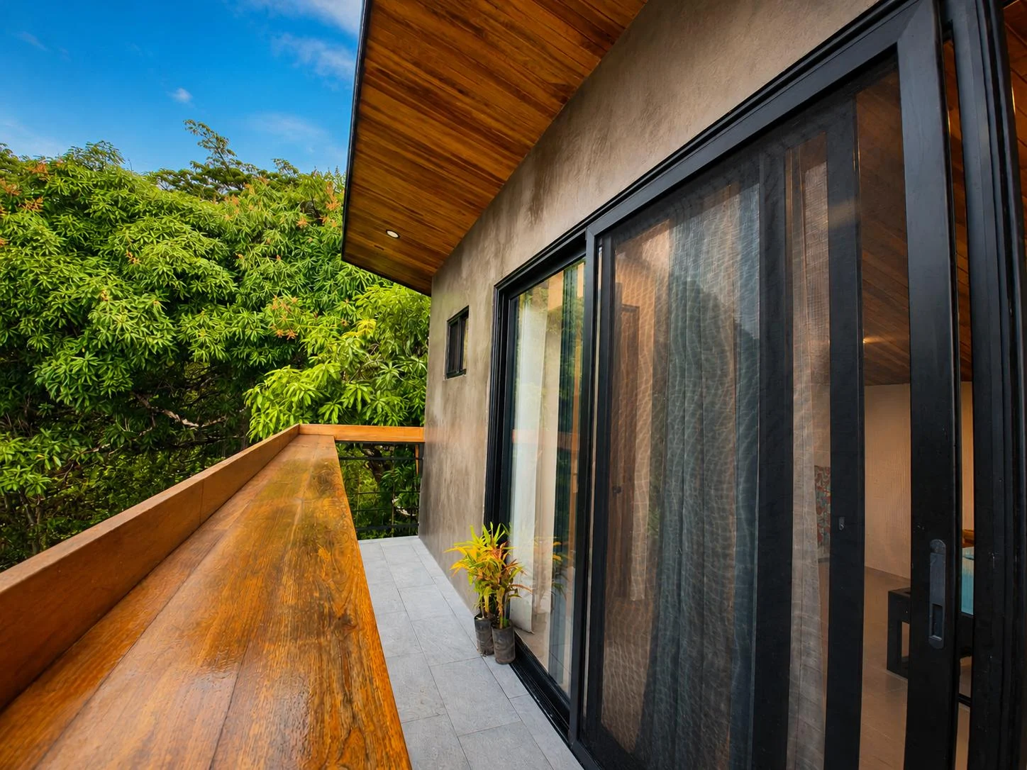 Timber balcony at the villa overlooking the trees